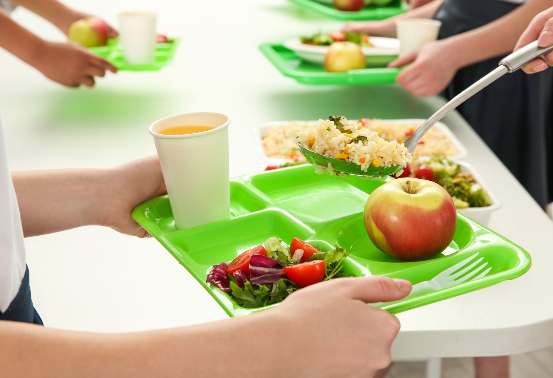 Photo of a child receiving lunch on a tray