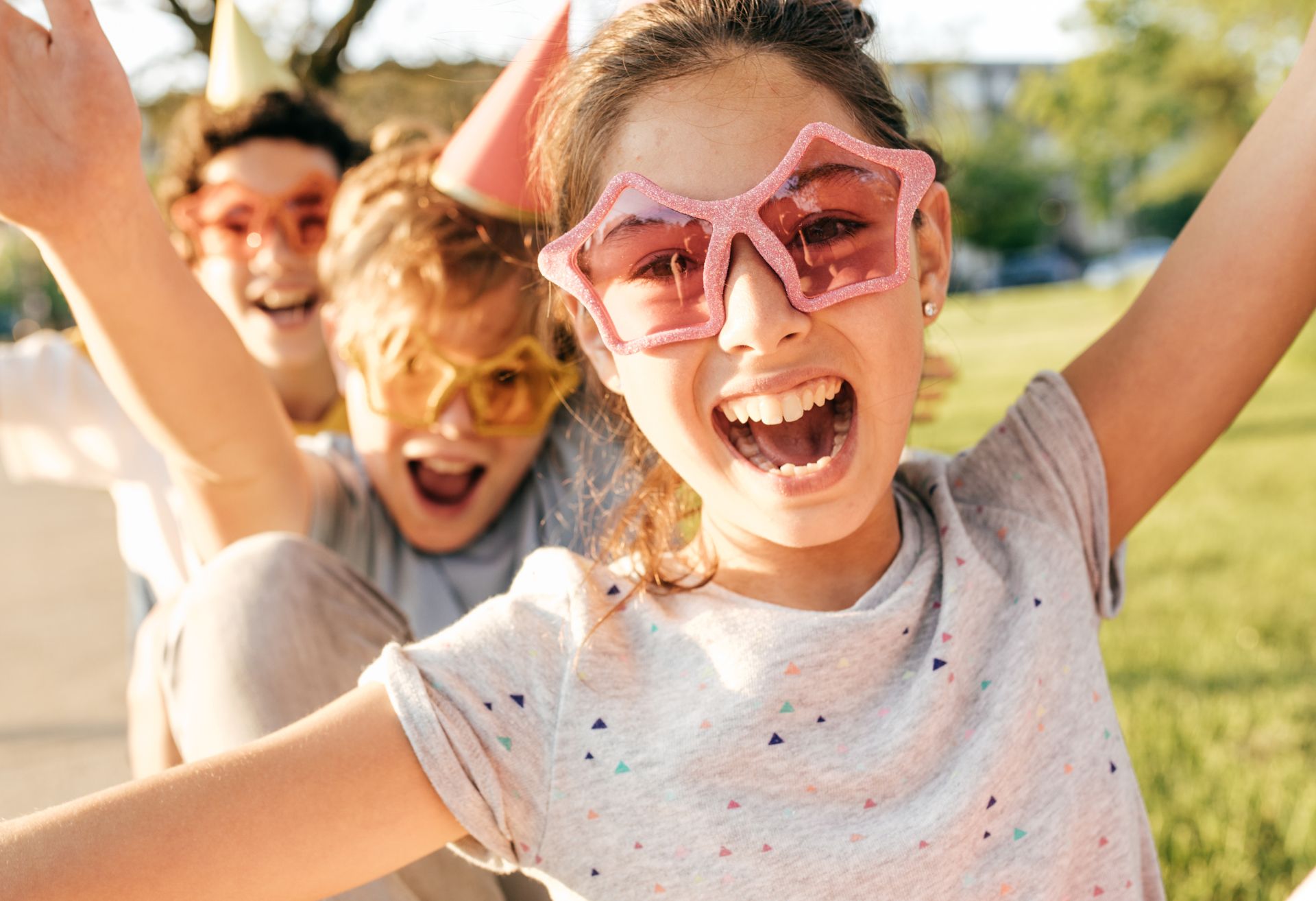 Image of children wearing funky glasses and having fun